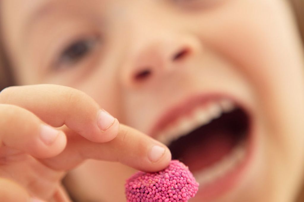 Little girl eating candy